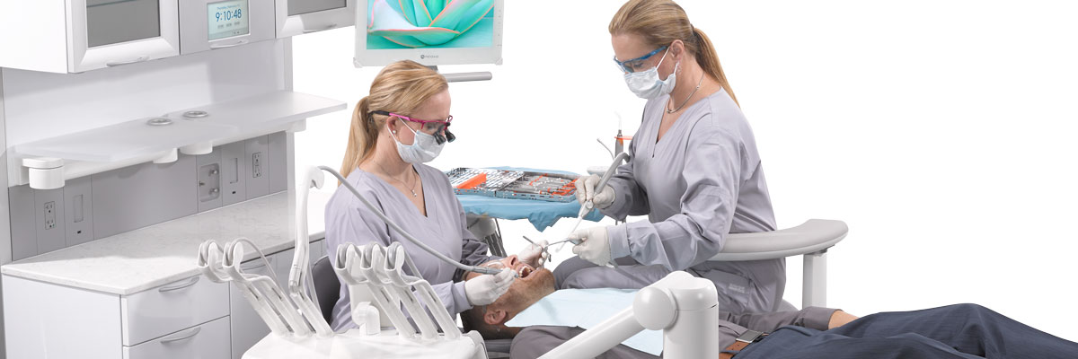 Dentist and assistant work in A-dec dental operatory